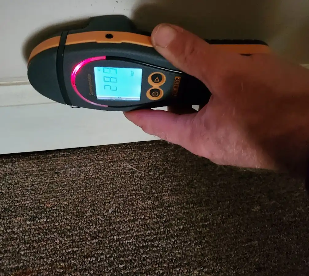 Moisture detection at baseboard during Storm Damage Restoration in Hinesville